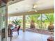 Relaxing screened patio with tropical views, ceiling fan, and comfortable seating at 805 Pickett Rd, The Villages, FL 32163