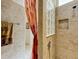 Shower featuring tile walls, a glass block window, and a built-in shower niche at 805 Pickett Rd, The Villages, FL 32163