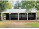 Spacious open barn featuring a metal roof and multiple bays, perfect for storage or equestrian activities at 8585 Nw 162Nd Ct, Morriston, FL 32668