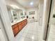 Bright bathroom featuring dual sinks, a soaking tub, and white tiled flooring at 8585 Nw 162Nd Ct, Morriston, FL 32668