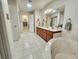 Spacious bathroom featuring dual sinks, a soaking tub, and white tiled flooring at 8585 Nw 162Nd Ct, Morriston, FL 32668