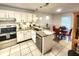 Charming kitchen featuring white cabinets, granite countertops, and stainless steel appliances at 8585 Nw 162Nd Ct, Morriston, FL 32668