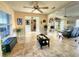 Inviting living room with tile flooring, ceiling fans, and a view into other rooms at 8585 Nw 162Nd Ct, Morriston, FL 32668