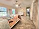 Bright main bedroom features tile flooring, ceiling fan, and natural light from the windows at 8585 Nw 162Nd Ct, Morriston, FL 32668