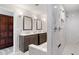 Modern bathroom featuring dual vanities, marble tile, and a separate walk-in shower with dual shower heads at 8947 Se 70Th Ter, Ocala, FL 34472