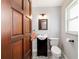 Charming half bathroom with a dark wood vanity and a patterned tile floor at 8947 Se 70Th Ter, Ocala, FL 34472