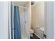 Clean, efficient bathroom featuring a shower stall with curtain and a separate toilet and sink area at 8947 Se 70Th Ter, Ocala, FL 34472