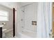 Bathroom featuring white subway tile in shower, designer tile flooring and dark wood vanity at 8947 Se 70Th Ter, Ocala, FL 34472