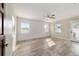 Bedroom featuring wood-look flooring, white shiplap, ceiling fan, and natural light from windows at 8947 Se 70Th Ter, Ocala, FL 34472