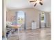 Bright bedroom featuring a ceiling fan, wood-look tile flooring, and large windows with blue curtains at 8947 Se 70Th Ter, Ocala, FL 34472