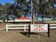 Leeward Air Ranch Red Barn Community Center sign next to building with white fence at 8947 Se 70Th Ter, Ocala, FL 34472