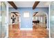 Inviting foyer with arched openings and tile flooring leading to living spaces with exposed beams at 8947 Se 70Th Ter, Ocala, FL 34472