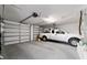 Spacious two car garage with ample storage and a white truck parked inside at 8947 Se 70Th Ter, Ocala, FL 34472