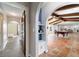 Hallway with archways connects rooms with tile and beam ceilings, leading to an open layout at 8947 Se 70Th Ter, Ocala, FL 34472