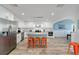 Contemporary kitchen featuring white cabinetry, granite countertops, and a stylish center island at 8947 Se 70Th Ter, Ocala, FL 34472