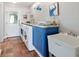 Well-equipped laundry room with a countertop, sink, and modern appliances at 8947 Se 70Th Ter, Ocala, FL 34472