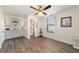 Cozy living room featuring wood-look flooring, a ceiling fan, and natural light from the window at 8947 Se 70Th Ter, Ocala, FL 34472