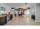 Open living space with wood beams, fireplace, bar, and open layout to other living spaces at 8947 Se 70Th Ter, Ocala, FL 34472