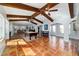 Open layout living room with exposed wood beams, tile flooring, and archways to connect the spaces at 8947 Se 70Th Ter, Ocala, FL 34472