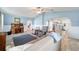 Living room with open layout, blue accent wall, view to the kitchen, and wood paneling detail at 8947 Se 70Th Ter, Ocala, FL 34472