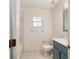 Cozy bathroom featuring blue vanity, tiled floors, and a shower-tub combination at 905 Se 12Th St, Ocala, FL 34471