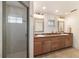 Bathroom featuring a double sink vanity, framed mirrors, and glass enclosed shower at 905 Se 12Th St, Ocala, FL 34471