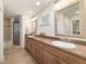 Bathroom featuring double sinks, framed mirrors, and a glass-enclosed shower at 905 Se 12Th St, Ocala, FL 34471