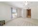 Bright bedroom with neutral carpet, ceiling fan and natural light from windows with privacy blinds at 905 Se 12Th St, Ocala, FL 34471