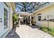 Charming courtyard featuring brick pavers, lush landscaping, and a covered outdoor space at 905 Se 12Th St, Ocala, FL 34471