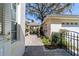 Charming courtyard featuring brick pavers, lush landscaping, and a covered outdoor space at 905 Se 12Th St, Ocala, FL 34471