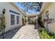 Charming courtyard featuring brick pavers, lush landscaping, and a covered outdoor space at 905 Se 12Th St, Ocala, FL 34471