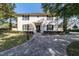 Charming two-story home with black shutters and brick driveway at 905 Se 12Th St, Ocala, FL 34471