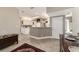 Spacious kitchen with white cabinetry and breakfast bar opens to the entryway at 905 Se 12Th St, Ocala, FL 34471