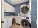 Convenient laundry room with modern stacked washer and dryer and ample cabinet space at 905 Se 12Th St, Ocala, FL 34471