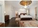 Spacious main bedroom with a decorative ceiling medallion and chandelier fixture at 905 Se 12Th St, Ocala, FL 34471