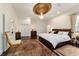 Well lit main bedroom with a decorative ceiling medallion, chandelier, and dark wood floors at 905 Se 12Th St, Ocala, FL 34471