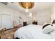 Bright main bedroom with a decorative ceiling medallion, chandelier, and staircase view at 905 Se 12Th St, Ocala, FL 34471