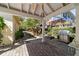 Covered patio featuring brick pavers, ceiling fan, and stainless steel BBQ grill at 905 Se 12Th St, Ocala, FL 34471