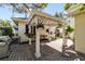 Covered patio featuring brick pavers, ceiling fan, and stainless steel BBQ grill at 905 Se 12Th St, Ocala, FL 34471