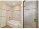 Tiled shower and bathtub combo with glass doors and chrome fixtures at 905 Se 12Th St, Ocala, FL 34471