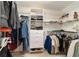 Walk-in closet with custom shelving and storage with hanging racks and built-in drawers at 905 Se 12Th St, Ocala, FL 34471