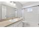 Bathroom showcasing a tub-shower combo, a white vanity, and excellent lighting to brighten your morning routine at 9493 Se 173Rd Ln, Summerfield, FL 34491