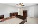 Empty bedroom with a ceiling fan, light-colored walls, and dark wooden furniture at 9493 Se 173Rd Ln, Summerfield, FL 34491