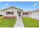 Charming home with red shutters, a brick accent wall, and well-maintained landscaping at 9493 Se 173Rd Ln, Summerfield, FL 34491