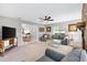 Bright living room with gray walls, a brick fireplace, and open access to the dining area at 9493 Se 173Rd Ln, Summerfield, FL 34491