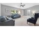 Bright living room with a ceiling fan, natural light, and neutral paint at 9493 Se 173Rd Ln, Summerfield, FL 34491