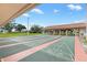 Outdoor shuffleboard courts with covered seating and well-maintained landscaping at 9493 Se 173Rd Ln, Summerfield, FL 34491