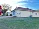 Back exterior showcasing a screened-in lanai with white trim and beige siding at 9681 Sw 97Th Ln, Ocala, FL 34481