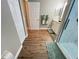 Bathroom featuring wood-look flooring, a white vanity, and a glass shower at 9681 Sw 97Th Ln, Ocala, FL 34481