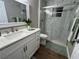 Well-lit bathroom with a modern vanity, marble-tiled shower with glass door, and a neutral color scheme at 9681 Sw 97Th Ln, Ocala, FL 34481